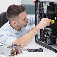 Ein Techniker schraubt an einem Computergehäuse